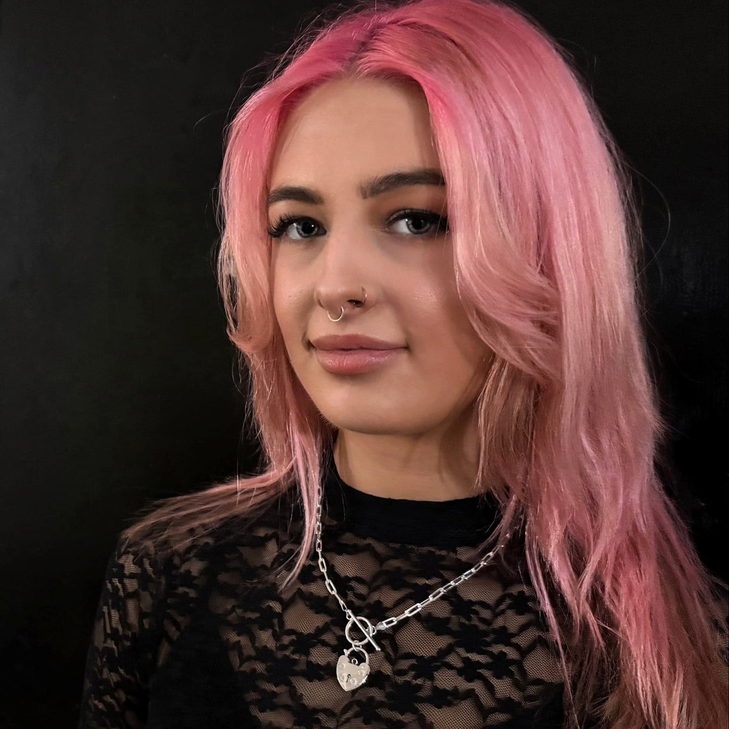 Model wearing ACCESS DENIED padlock necklace from ROCKSTAR★REFINEMENTS, styled against a black background