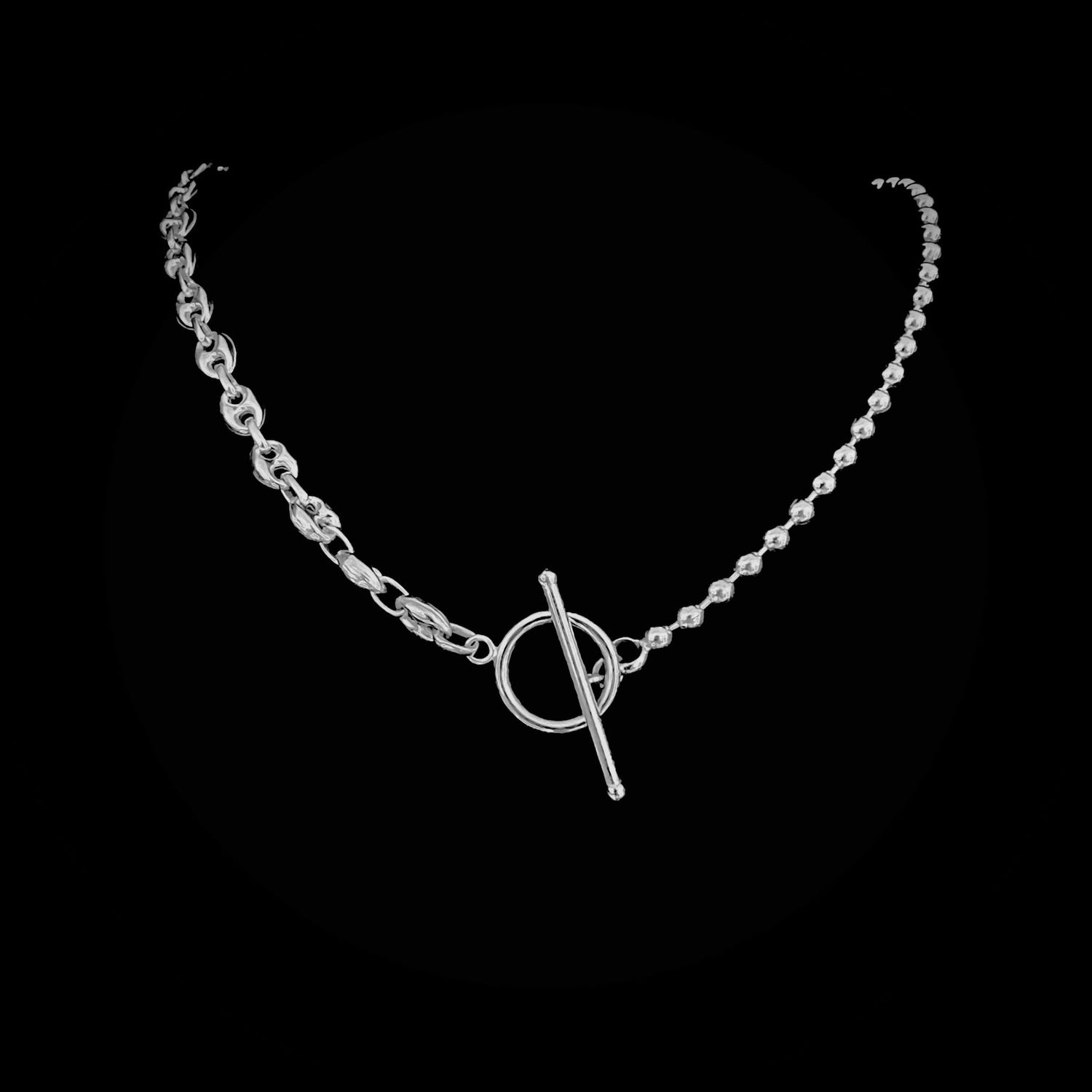 Sterling silver DUALITY chain necklace featuring mixed link styles and a toggle clasp. Photographed on a  black background.