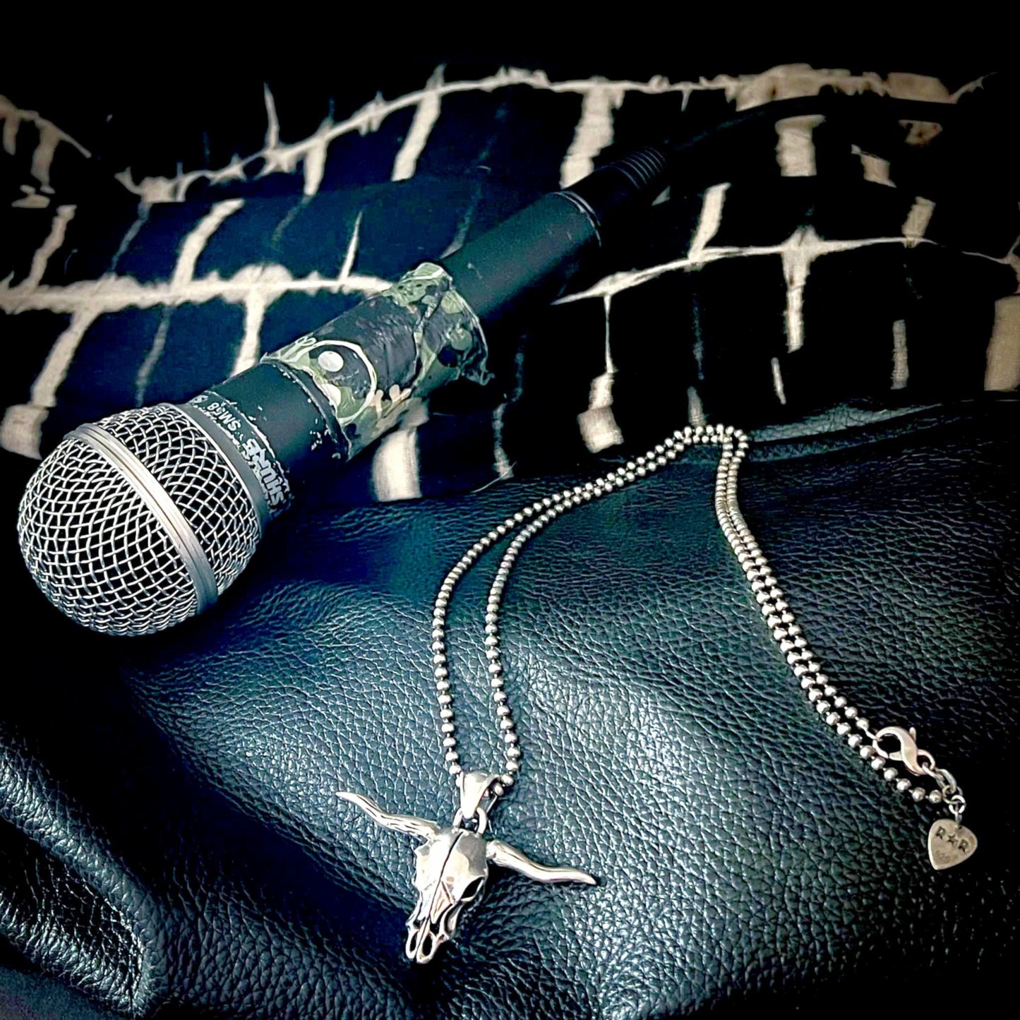 Sterling silver POINT OF NO RETURN skull pendant thrown on stage clothes and microphone