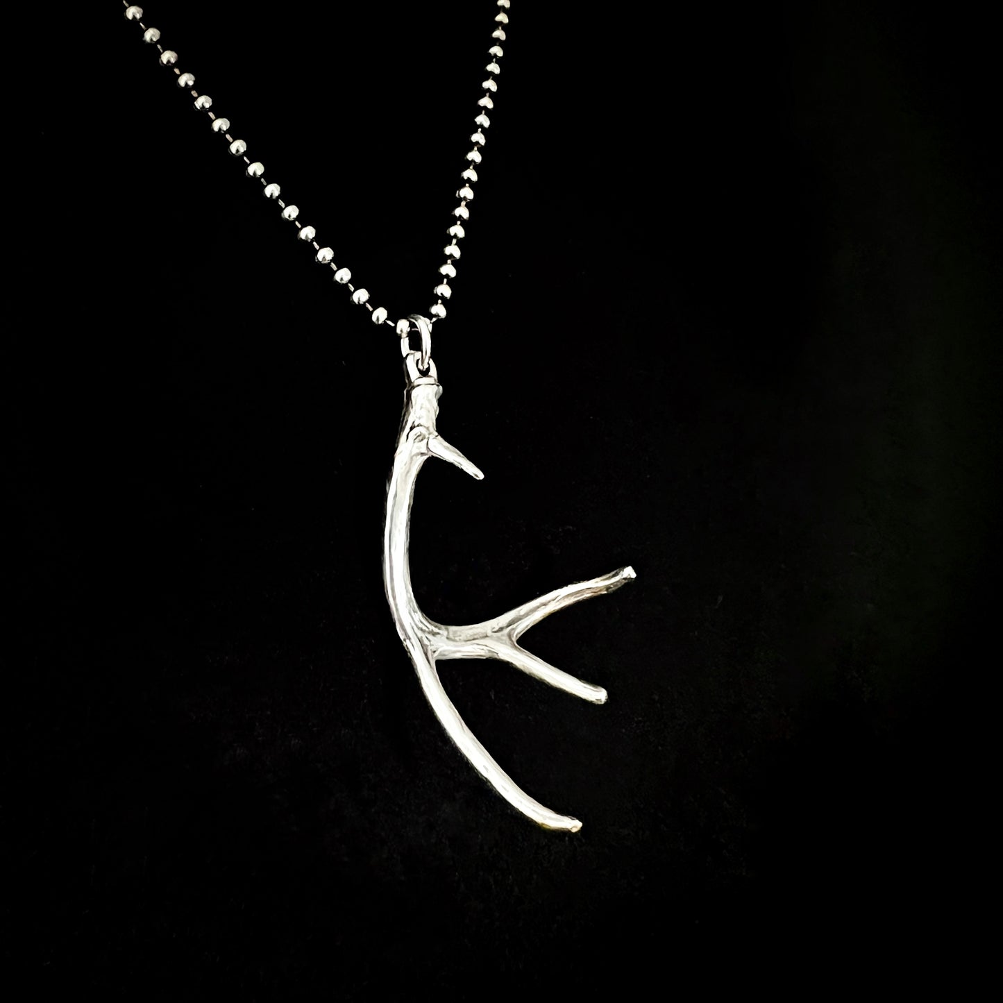 NO EYE DEER — sterling silver antler pendant photographed on an oxidised ball chain against a black background by ROCKSTAR★REFINEMENTS