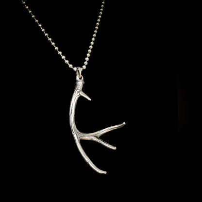 NO EYE DEER on high-shine ball chain photographed on black background 