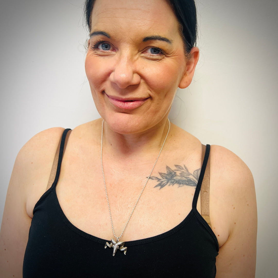 The Untamed wearing the NO FLOCKS GIVEN pendant necklace.
