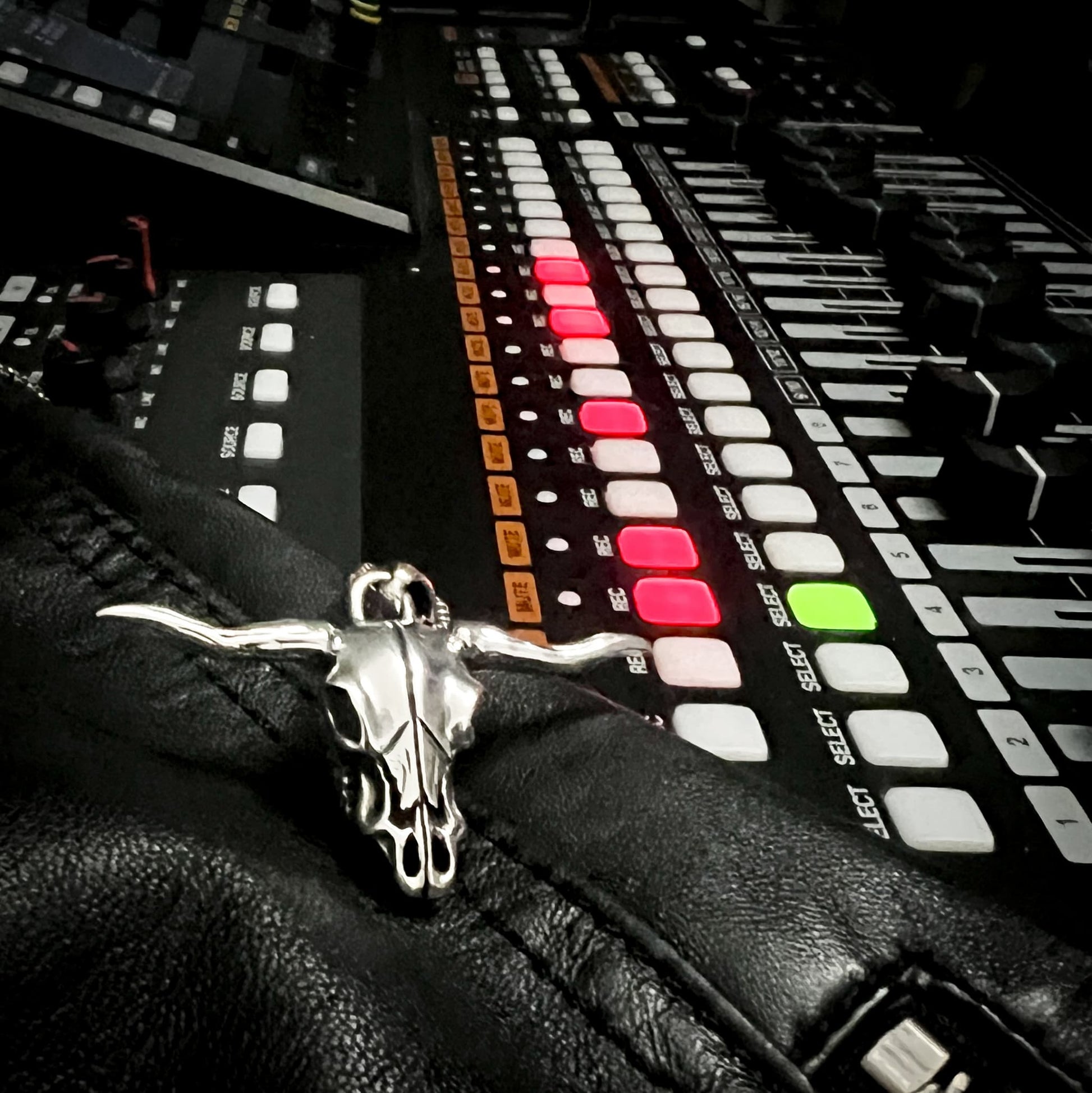 Sterling silver Point of No Return skull pendant from Rockstar Refinements, styled on a recording desk with faders