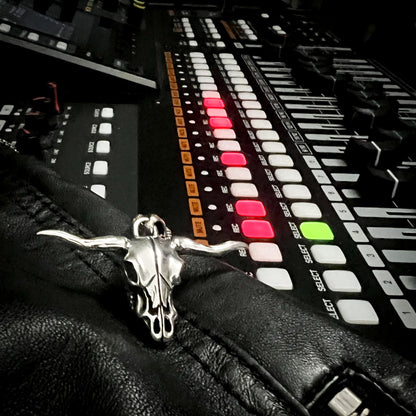 Sterling silver Point of No Return skull pendant from Rockstar Refinements, styled on a recording desk with faders