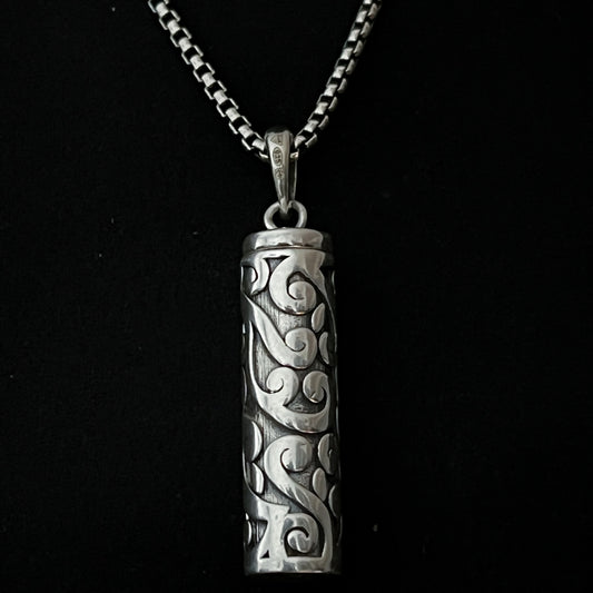 Sterling silver POISON IS THE CURE locket pendant close up