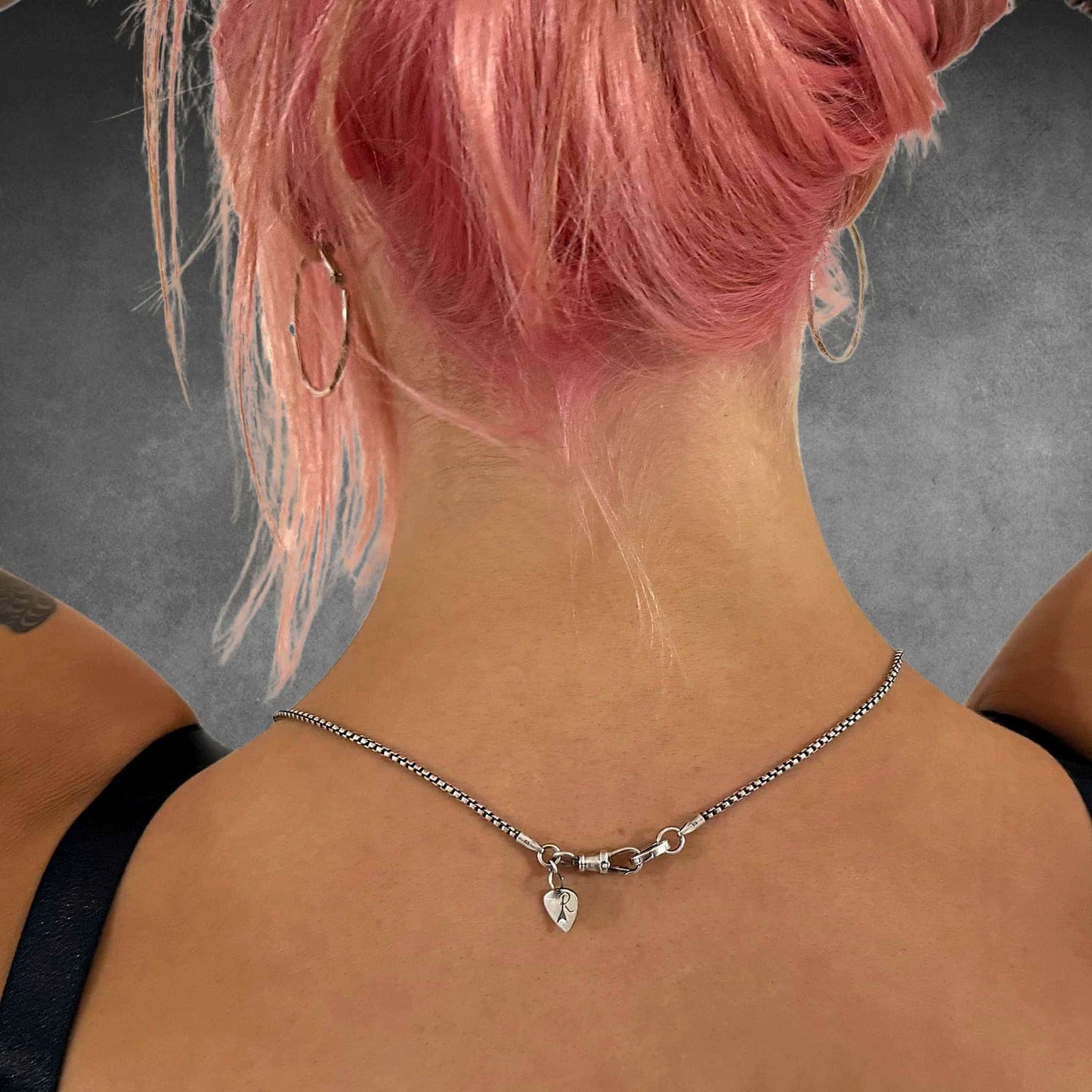 Rear view of box chain showing clasp detail worn by female model 