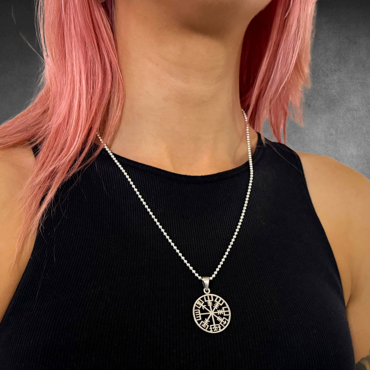 RECKLESS ROUTE compass on a 22-inch polished 2.5mm ball chain modelled by a girl with pink hair 