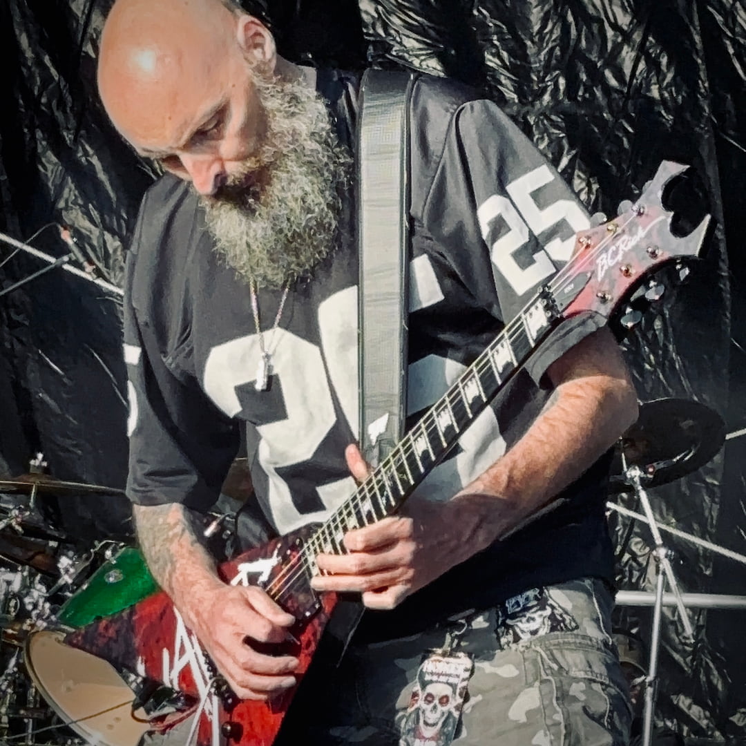 Stuart "Rage" Dixon performing with Live Undead, wearing the ROCKSTAR★REFINEMENTS™ 'ANTIDOTE (NOT INCLUDED) pendant on stage.