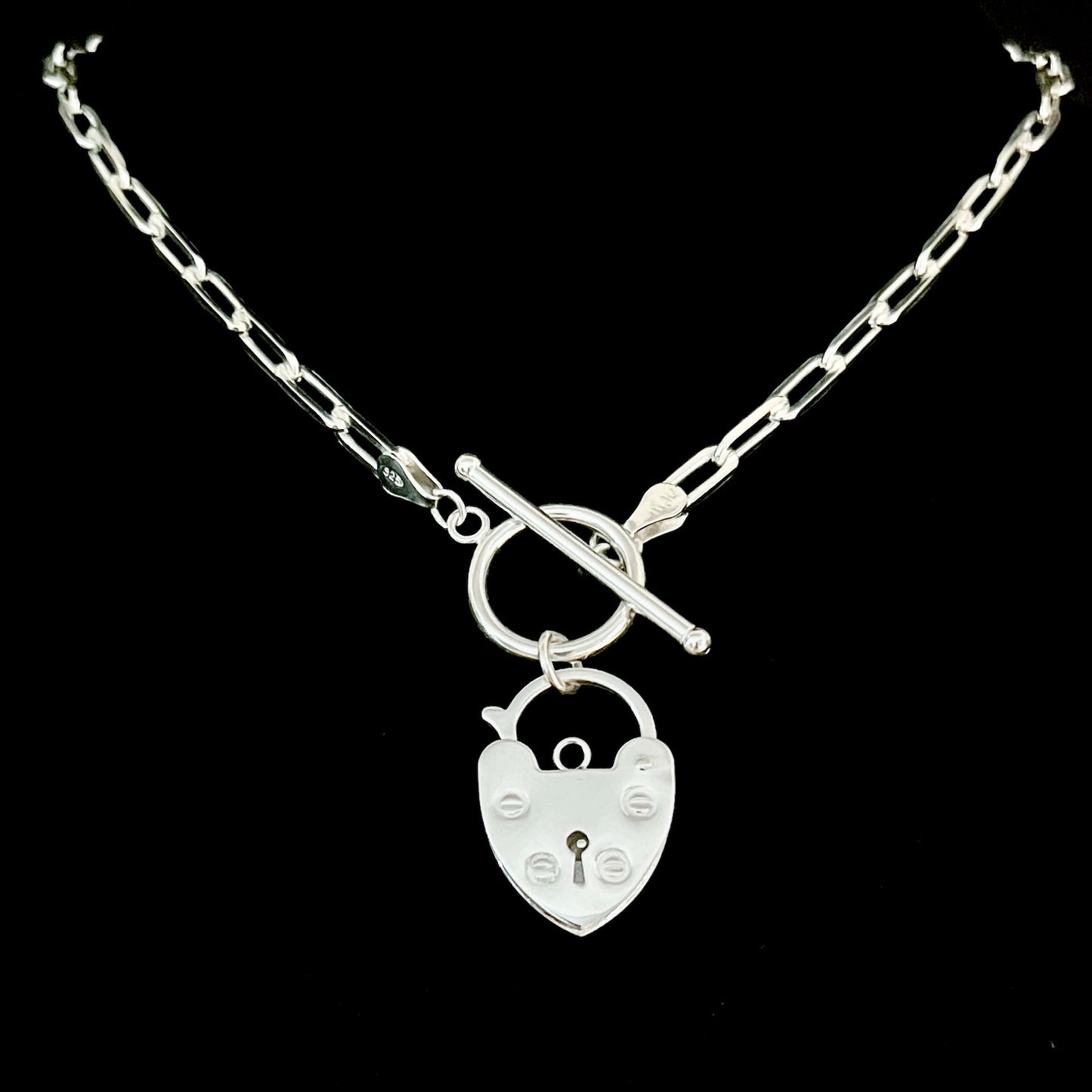 Sterling-silver retro padlock necklace on an 18-inch paperclip chain by ROCKSTAR★REFINEMENTS™, photographed on a black background.