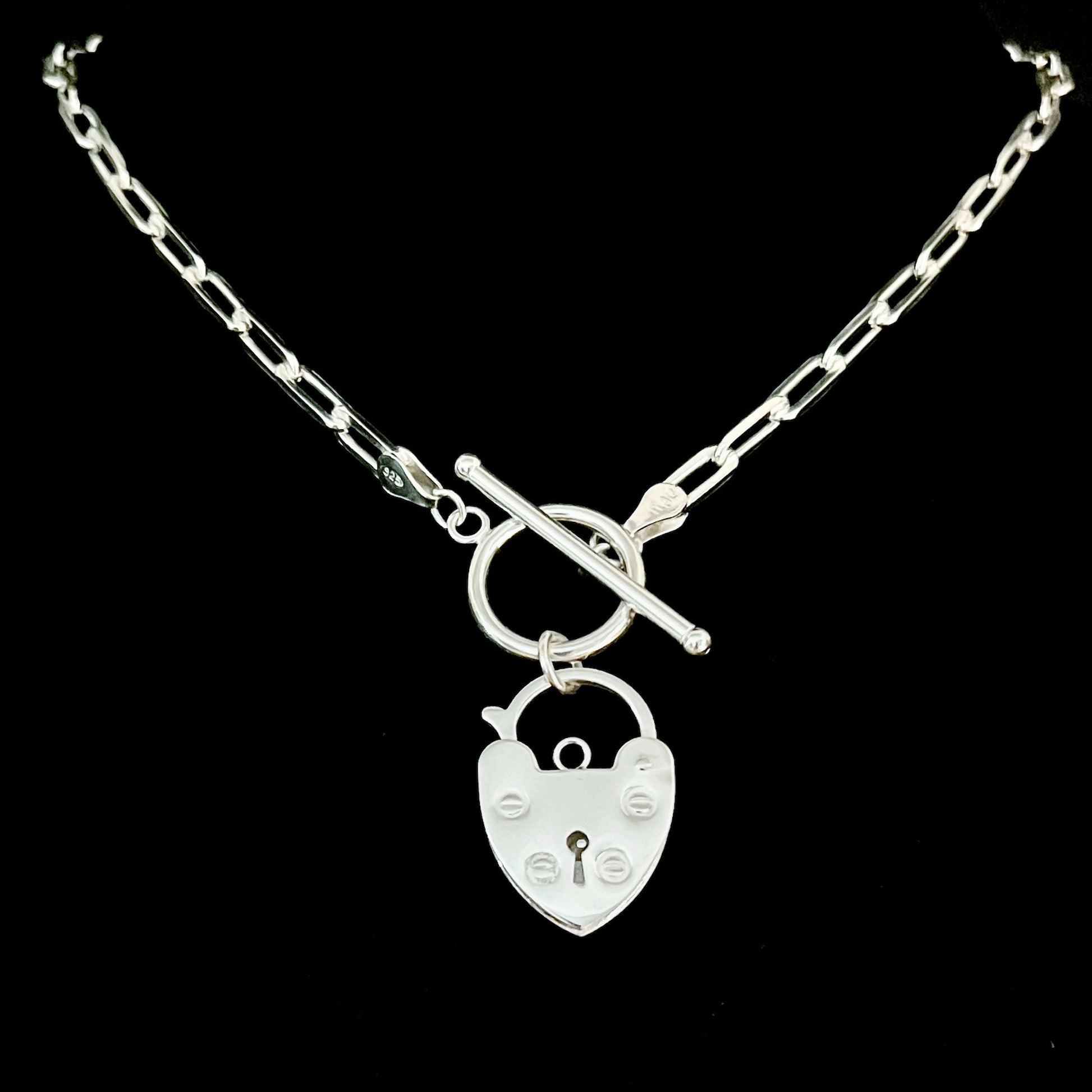 Sterling-silver retro padlock necklace on an 18-inch paperclip chain by ROCKSTAR★REFINEMENTS™, photographed on a black background.