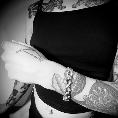 Model with tattooed arms and chest wearing AFTER PARTY sterling silver bracelet by ROCKSTAR★REFINEMENTS™