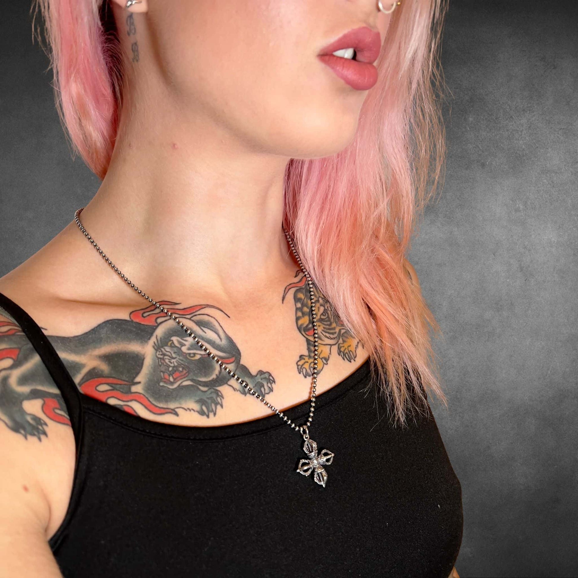 Person with neck and chest tattoos wearing ALTAR EGO sterling silver necklace by ROCKSTAR★REFINEMENTS™