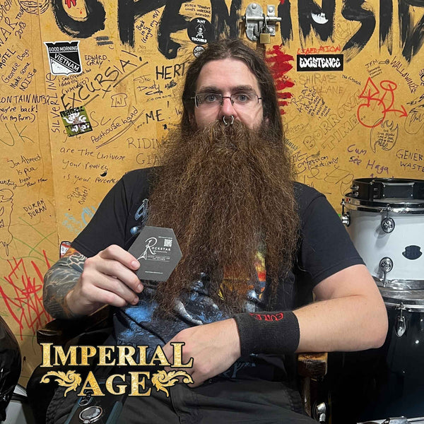 Dan 'Beardy' Quiney from IMPERIAL AGE holding a R★R beer mat