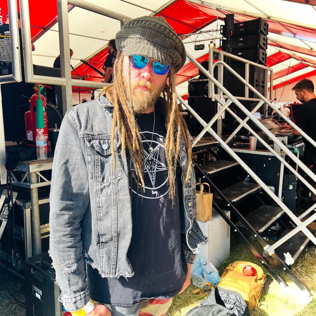 Chris Newman of Robbed Zombie backstage at a festival wearing the ROCKSTAR★REFINEMENTS™ CROW'D CONTROL crow skull pendant.