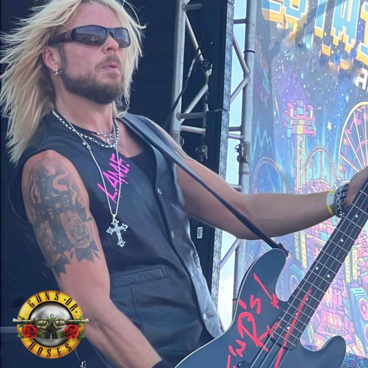 Dermo from Guns Or Roses performing on the main stage, wearing THE OUTLAW'S CROSS pendant by ROCKSTAR★REFINEMENTS™
