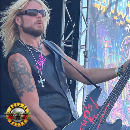 Dermo from Guns Or Roses performing on the main stage, wearing THE OUTLAW'S CROSS pendant by ROCKSTAR★REFINEMENTS™