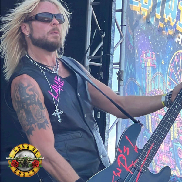Dermo from Guns Or Roses performing on the main stage, wearing THE OUTLAW'S CROSS pendant by ROCKSTAR★REFINEMENTS™