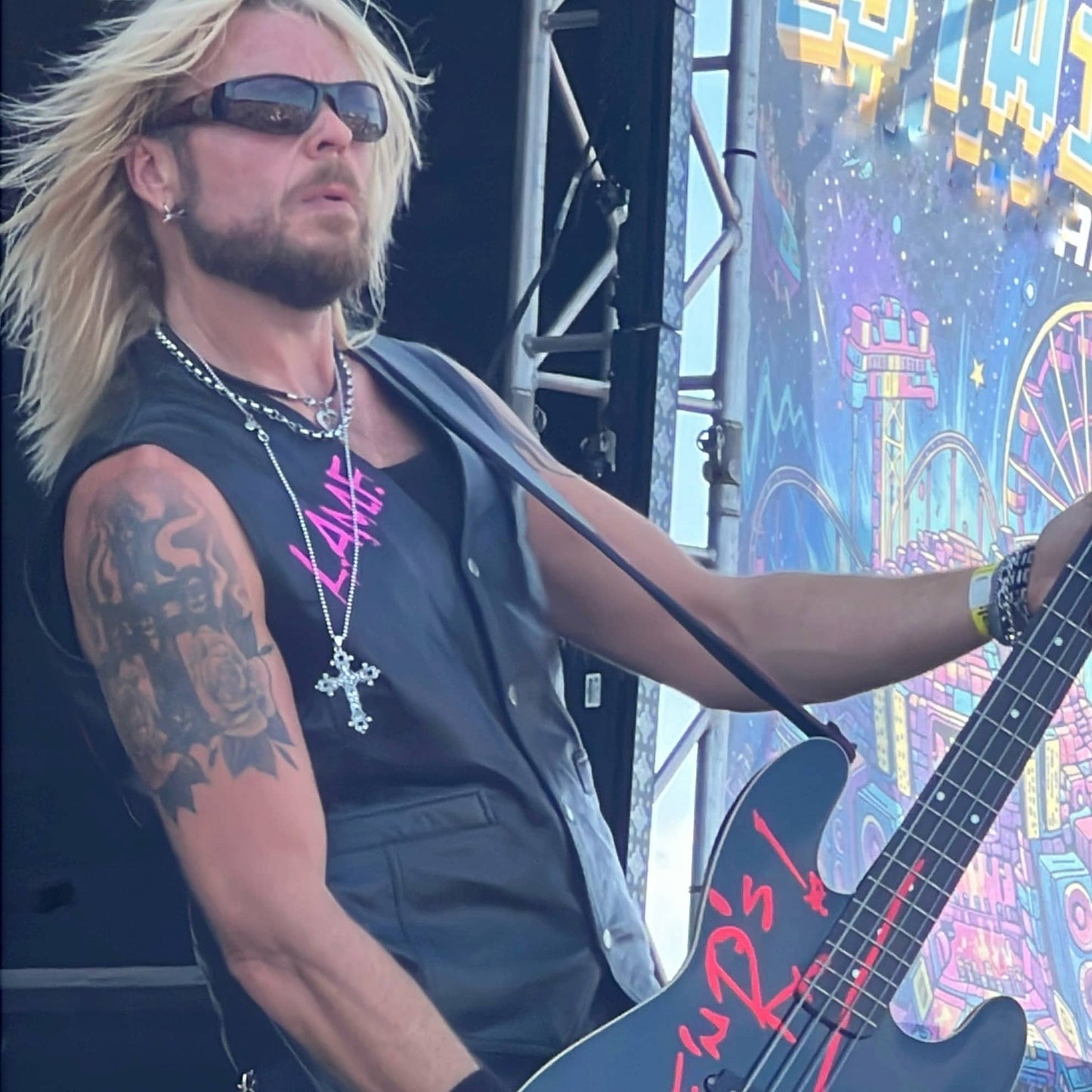 Dermo from Guns Or Roses performing on the main stage, wearing THE OUTLAW'S CROSS pendant by ROCKSTAR★REFINEMENTS™