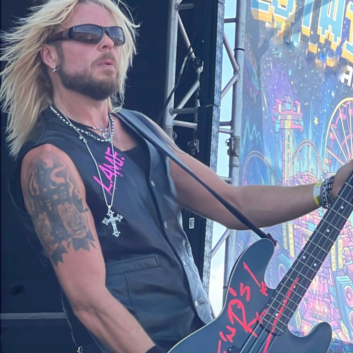 Dermo from Guns Or Roses performing on the main stage, wearing THE OUTLAW'S CROSS pendant by ROCKSTAR★REFINEMENTS™