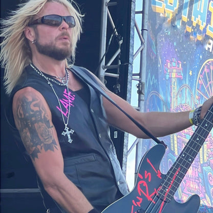 Dermo from Guns Or Roses performing on the main stage, wearing THE OUTLAW'S CROSS pendant by ROCKSTAR★REFINEMENTS™