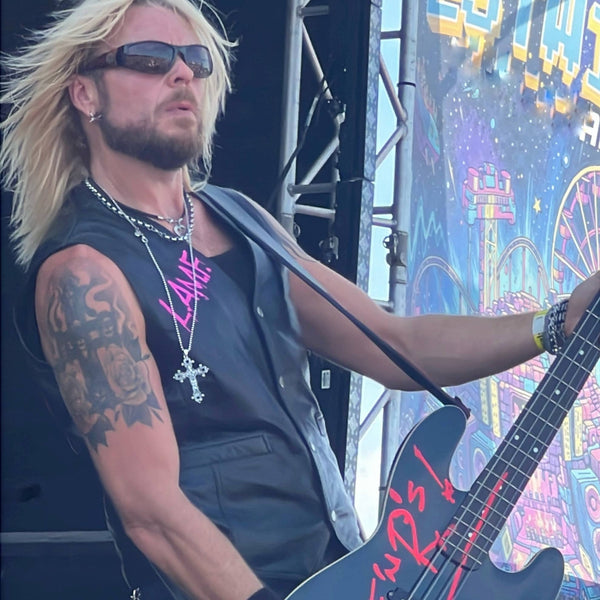 Dermo from Guns Or Roses performing on the main stage, wearing THE OUTLAW'S CROSS pendant by ROCKSTAR★REFINEMENTS™