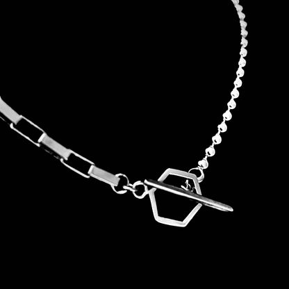 Close up view of front or back fastening geometric toggle and bar clasp. 