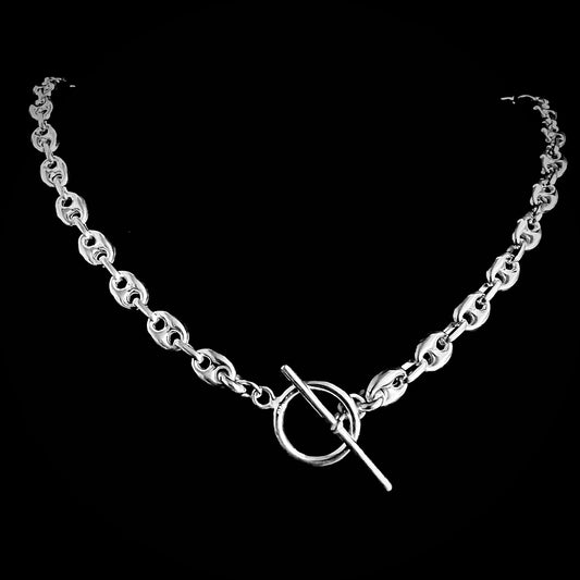 'DEFIANCE' bold anchor chain necklace with toggle bar clasp. Photographed on black background.