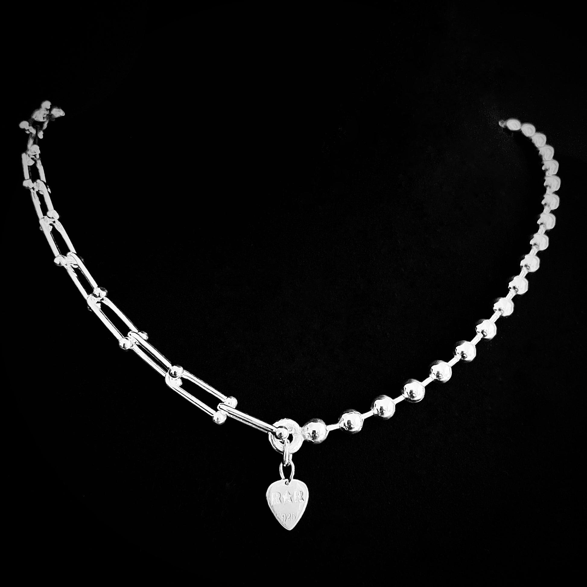 Dual chain sterling silver necklace featuring architectural links and ball chain rear view showing branded R★R jewellery tag on black background. 