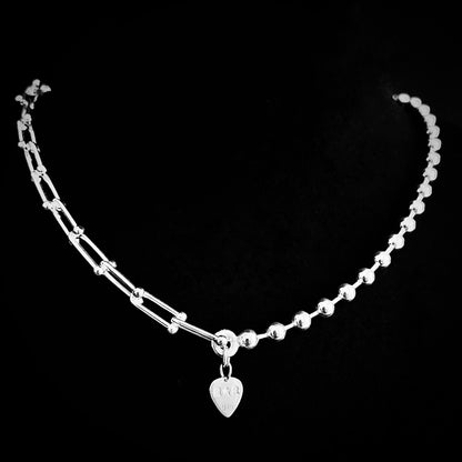 Dual chain sterling silver necklace featuring architectural links and ball chain rear view showing branded R★R jewellery tag on black background. 