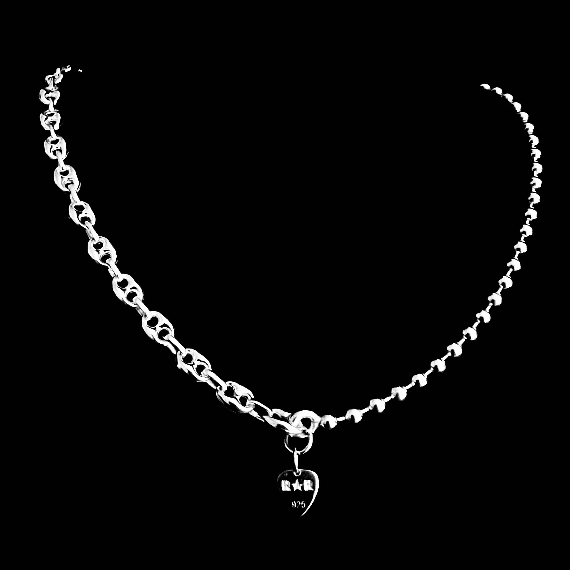 Sterling silver DUALITY chain necklace featuring mixed link styles. Back of necklace photographed on a  black background.