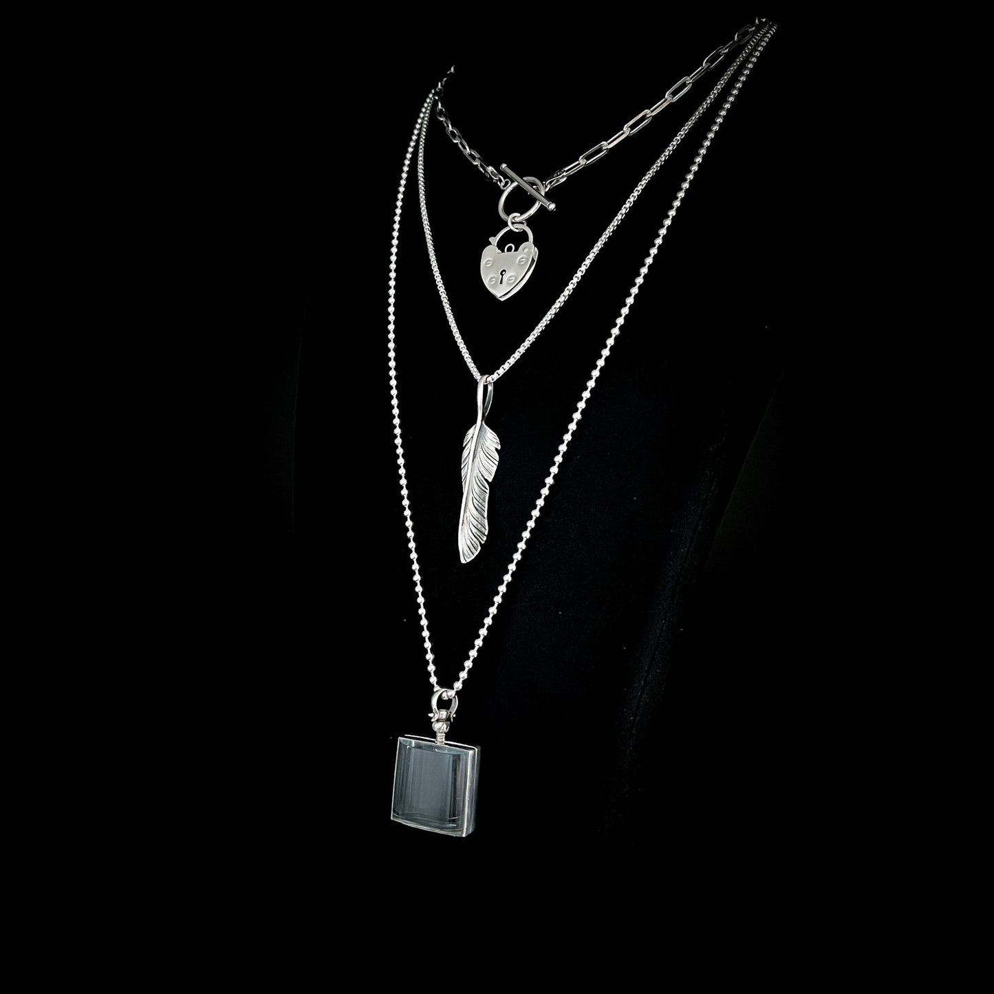 ACCESS DENIED, PLUCK OFF, and ASHES OF HIS HOODIE pendants from the EXES & EXCUSES collection by ROCKSTAR★REFINEMENTS™, layered on polished silver chains against a black background.