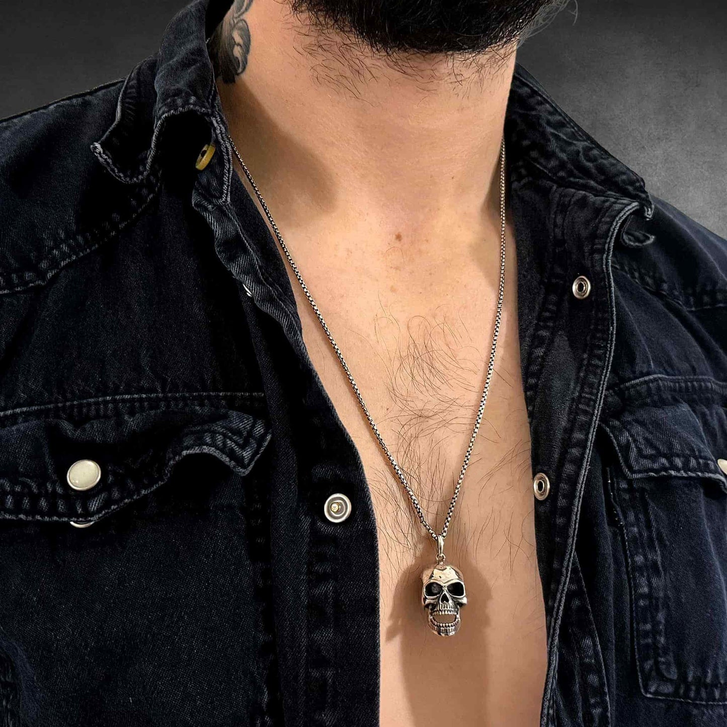 FINAL LAUGH pendant on 26 inch oxidised box chain worn by male model