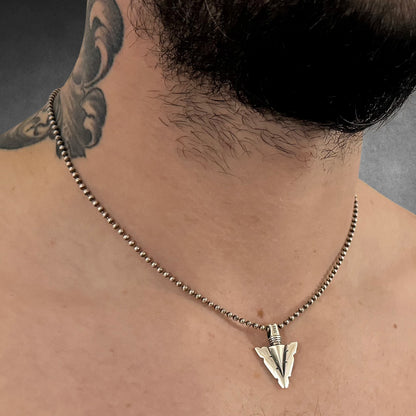 Model wearing FINAL POINT sterling silver arrowhead pendant on 18-inch oxidised ball chain by ROCKSTAR★REFINEMENTS™