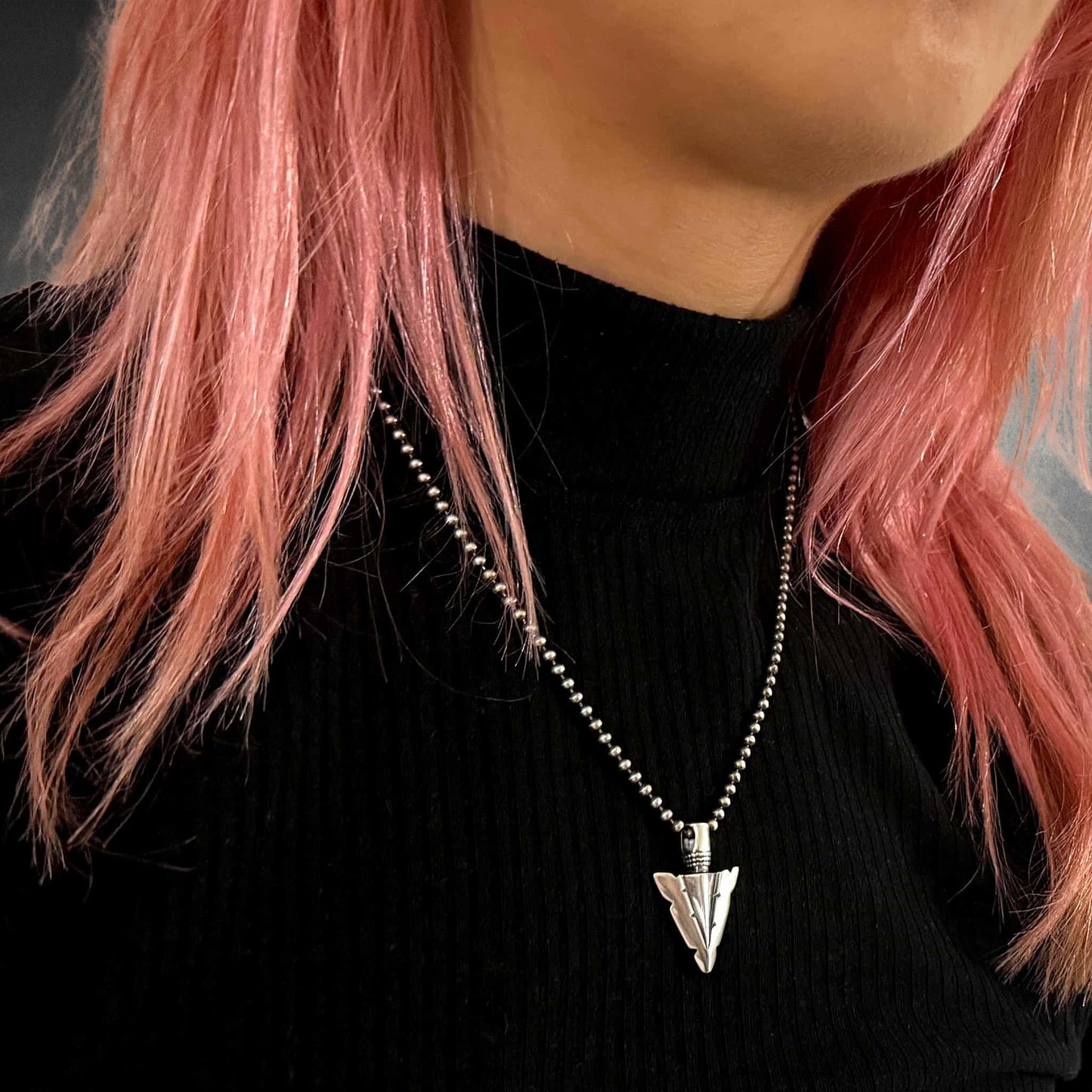 Model wearing FINAL POINT sterling silver arrowhead pendant on 18-inch oxidised ball chain by ROCKSTAR★REFINEMENTS™