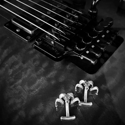 FLOCKING FORMAL solid silver cufflinks photographed next to bridge of ESP guitar