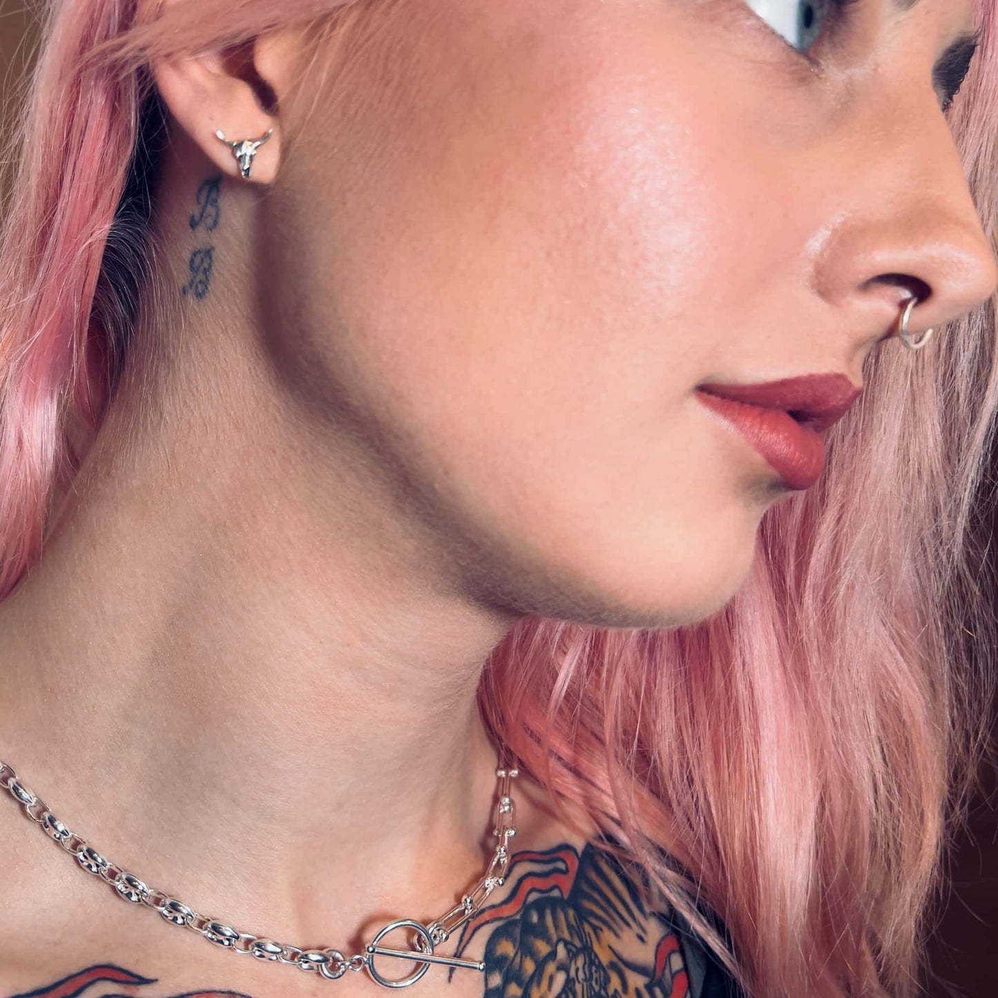 Close-up of model wearing FUSION necklace, and BULL HEADED sterling silver earrings
