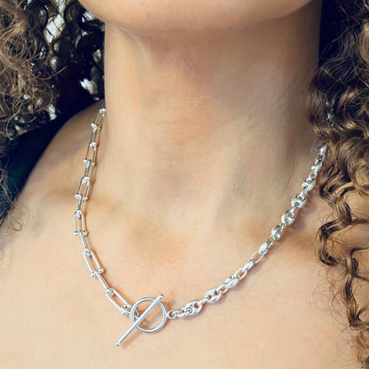 Close-up of FUSION silver necklace with mixed chain detail and toggle clasp from the DUALITY range, on model.