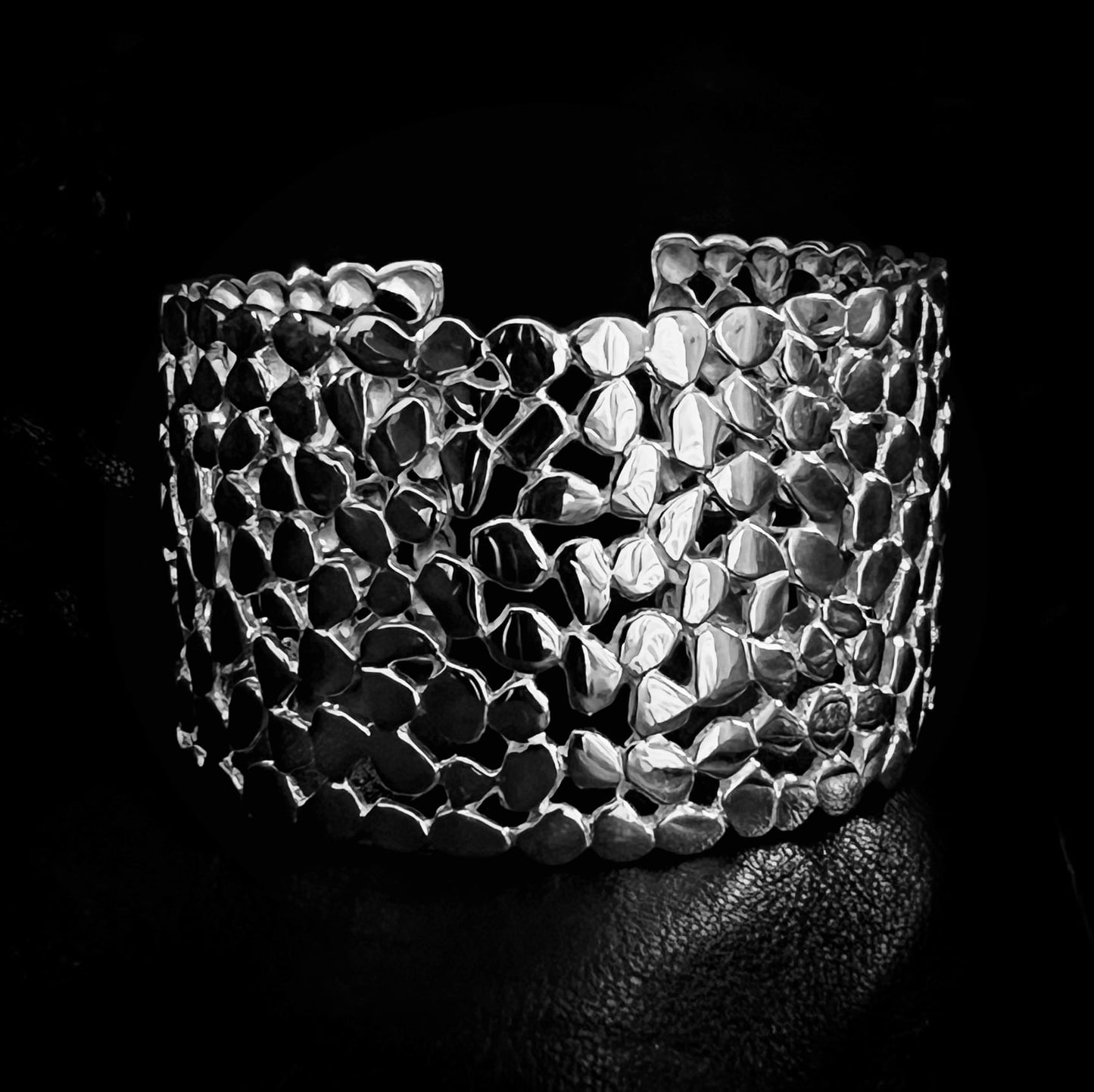 'HEADLINER' solid silver statement bangle by ROCKSTAR★REFINEMENTS™ photographed close-up on a black background
