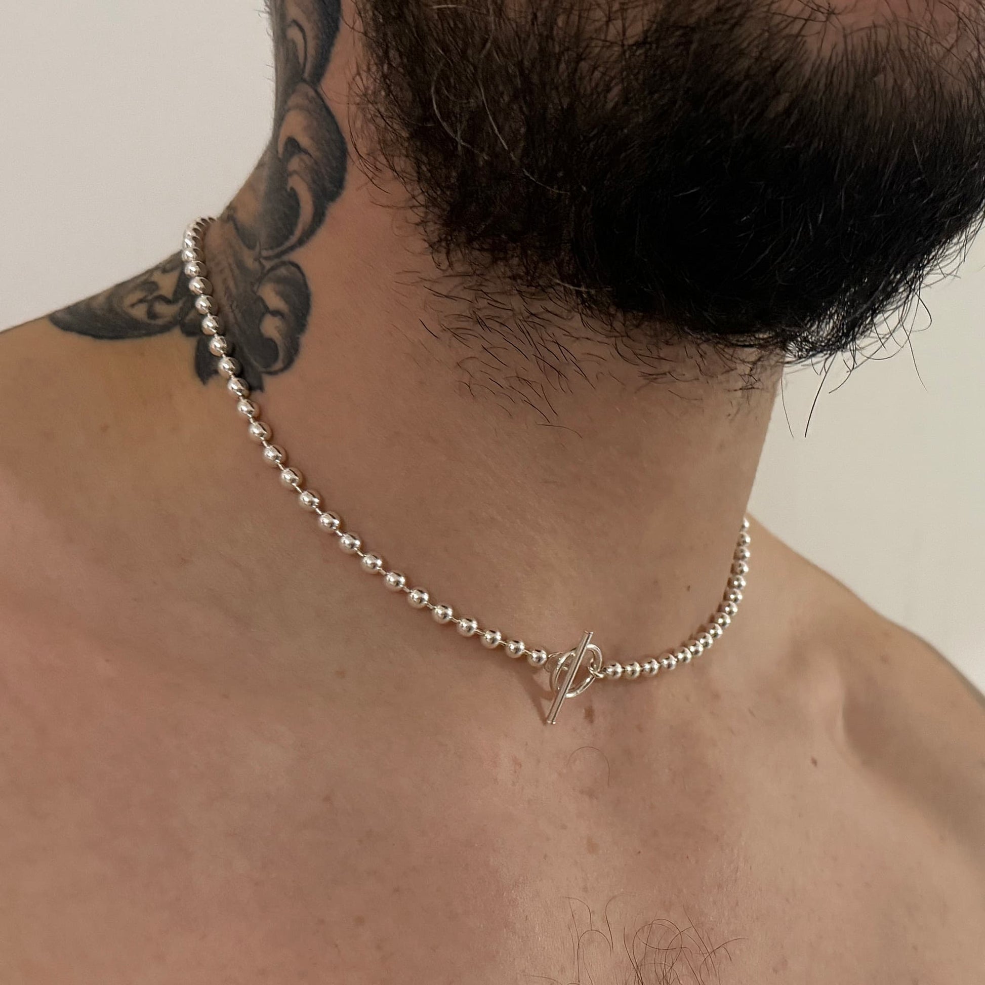 LAYER SLAYER polished 5mm ball chain. Photographed on tattooed male model.