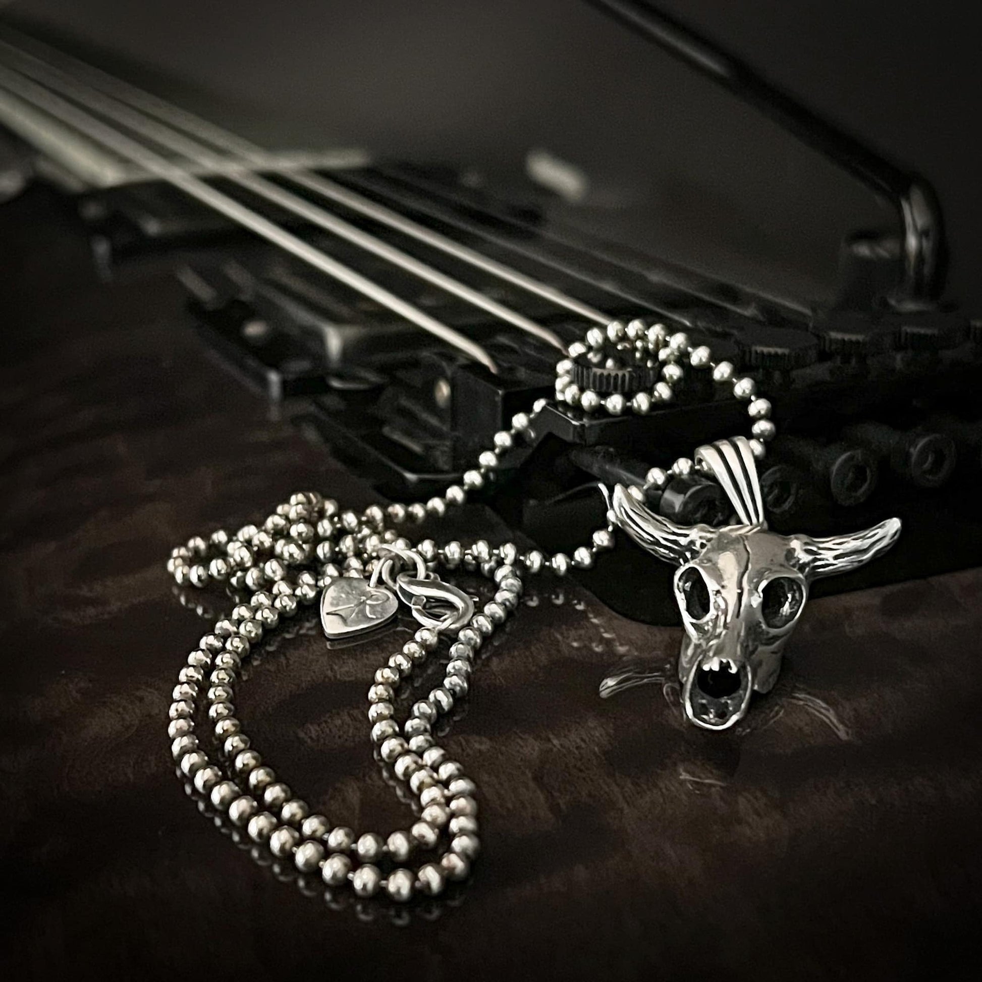 NO BS bull skull on 2.5mm ball chain. Photographed on a ESP guitar 