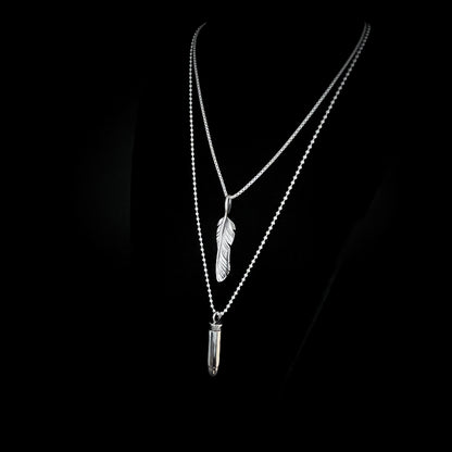 THE ONE STEP COOL KIT — sterling silver layered necklaces featuring WINGING IT on a 26-inch box chain and ONE HIT WONDER bullet pendant on a 30-inch 2.5 mm ball chain, photographed on a black background, side view, by ROCKSTAR★REFINEMENTS