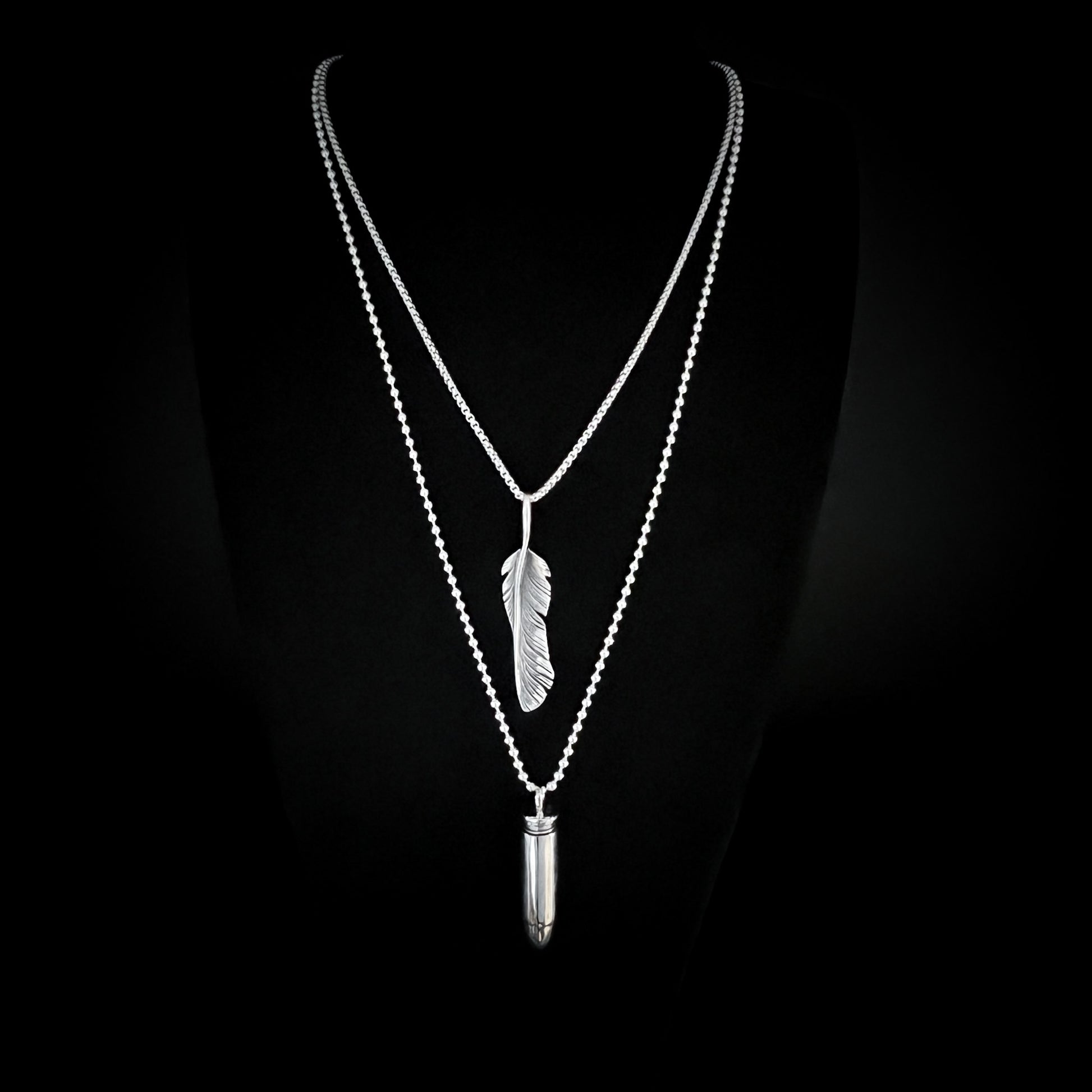 THE ONE STEP COOL KIT — sterling silver layered chains featuring WINGING IT on a 26-inch box chain and ONE HIT WONDER bullet pendant on a 30-inch 2.5 mm ball chain, photographed on a black background by ROCKSTAR★REFINEMENTS