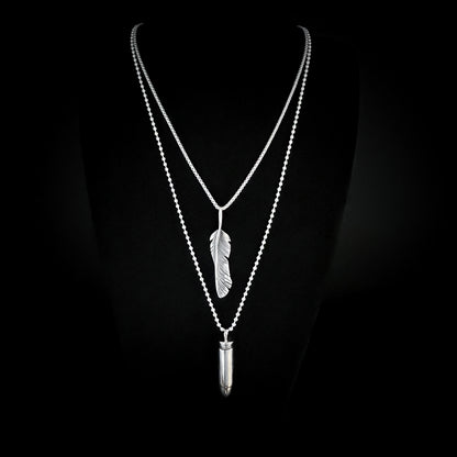 THE ONE STEP COOL KIT — sterling silver layered chains featuring WINGING IT on a 26-inch box chain and ONE HIT WONDER bullet pendant on a 30-inch 2.5 mm ball chain, photographed on a black background by ROCKSTAR★REFINEMENTS