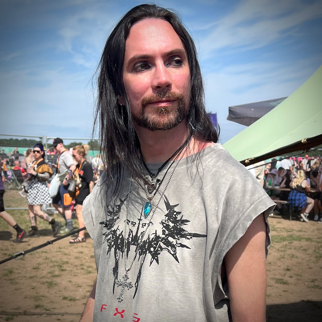 Person at a rock festival spotted in the wild wearing OUTLAW'S CROSS sterling silver pendant 