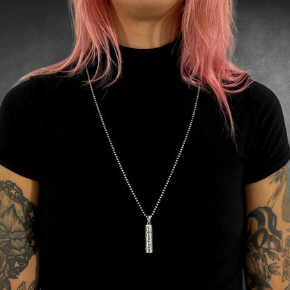 POISON IS THE CURE on 2.5mm oxidised 28-inch 2.5mm ball chain, worn by tattooed model