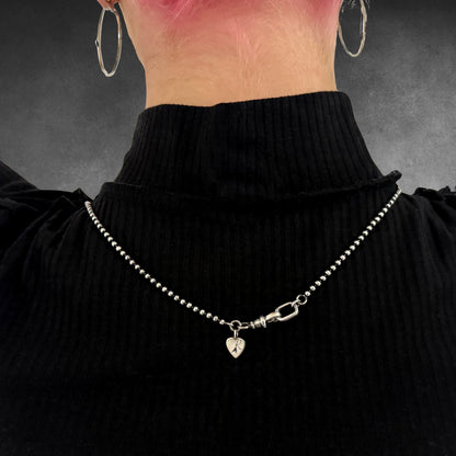 POISON IS THE CURE on 2.5mm oxidised 28-inch 2.5mm ball chain, from the rear.