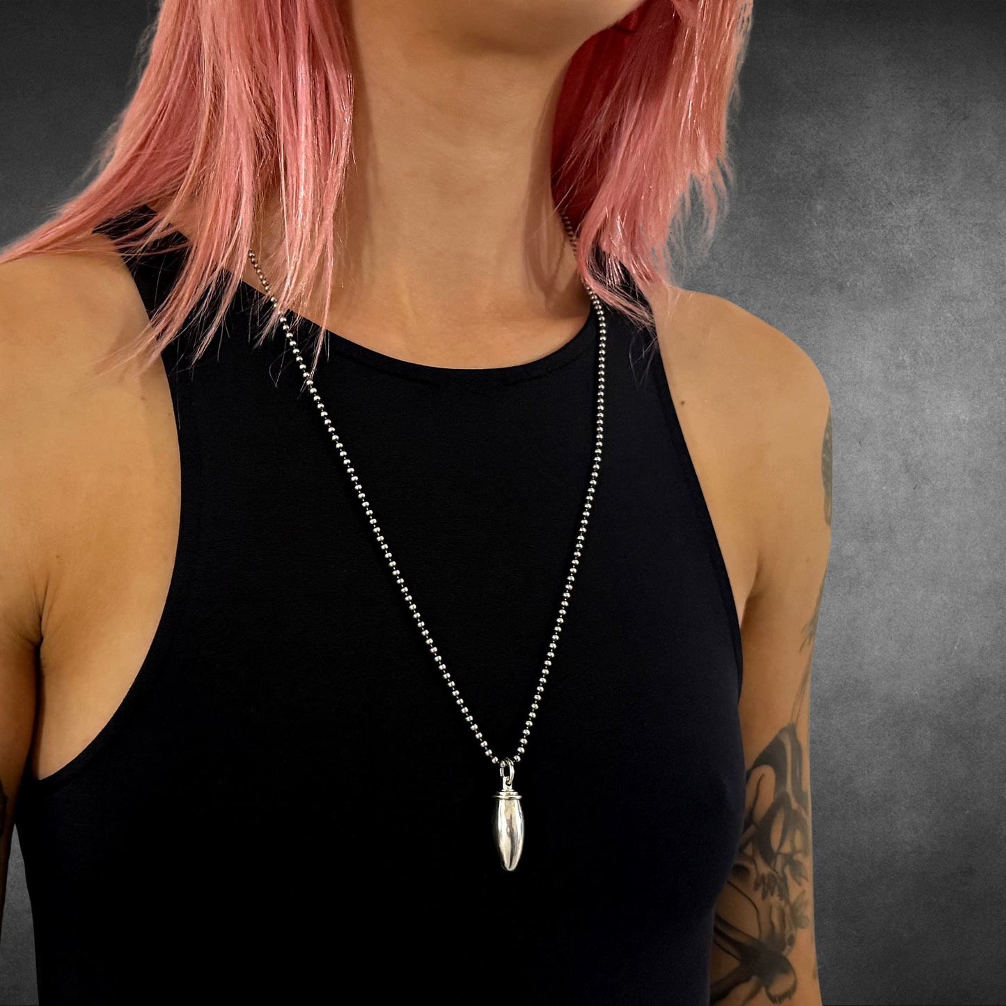 Model wearing PRETTY LOADED vial pendant on 28-inch 2.5mm oxidised sterling silver ball chain 