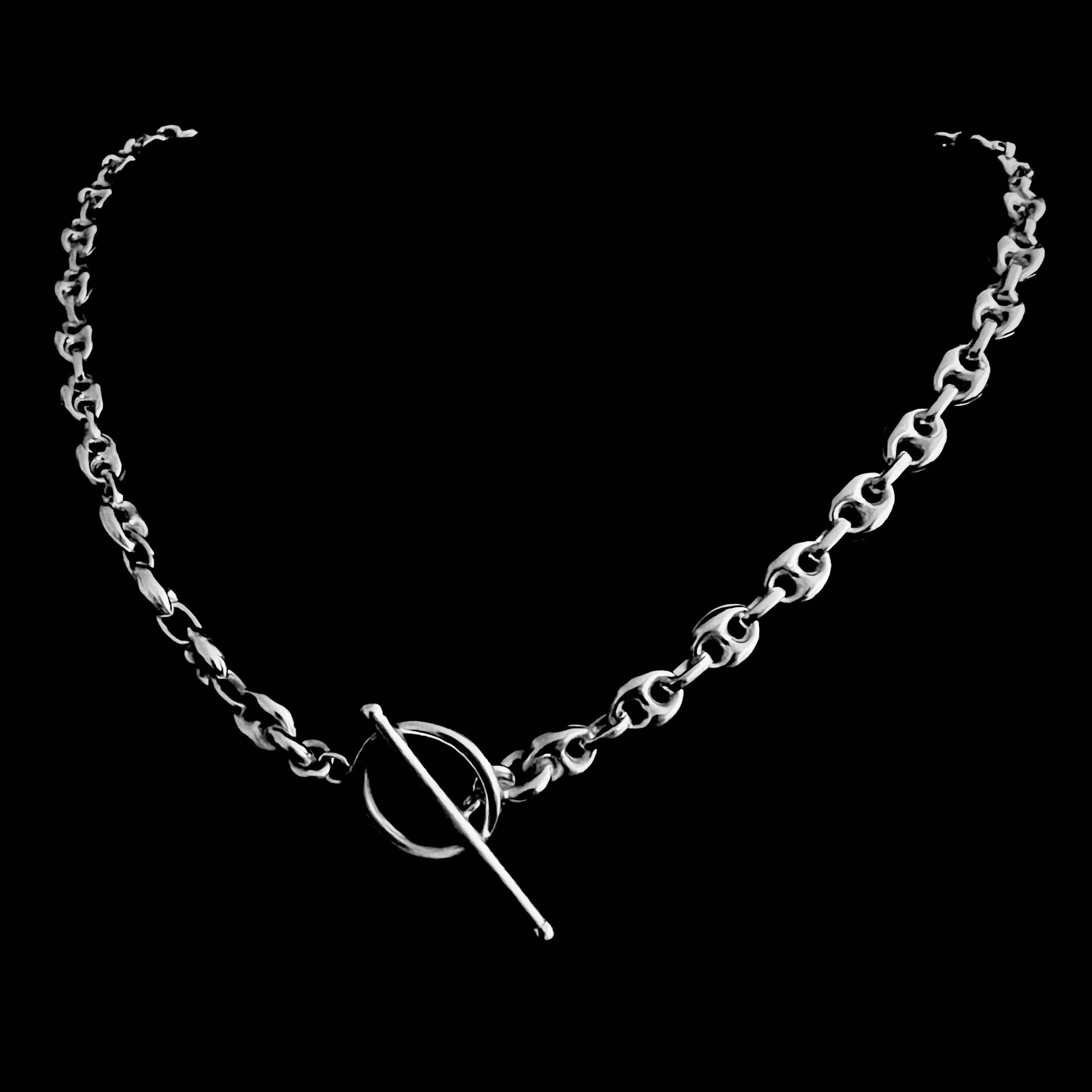 REBEL — Sterling silver anchor chain with front toggle clasp — smooth, high-polish links, photographed on a black background.