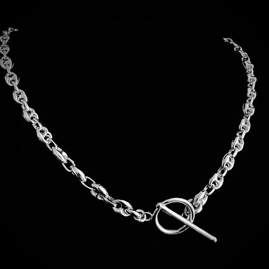 REBEL — Sterling silver anchor chain with front toggle clasp — smooth, high-polish links, photographed on a black background.