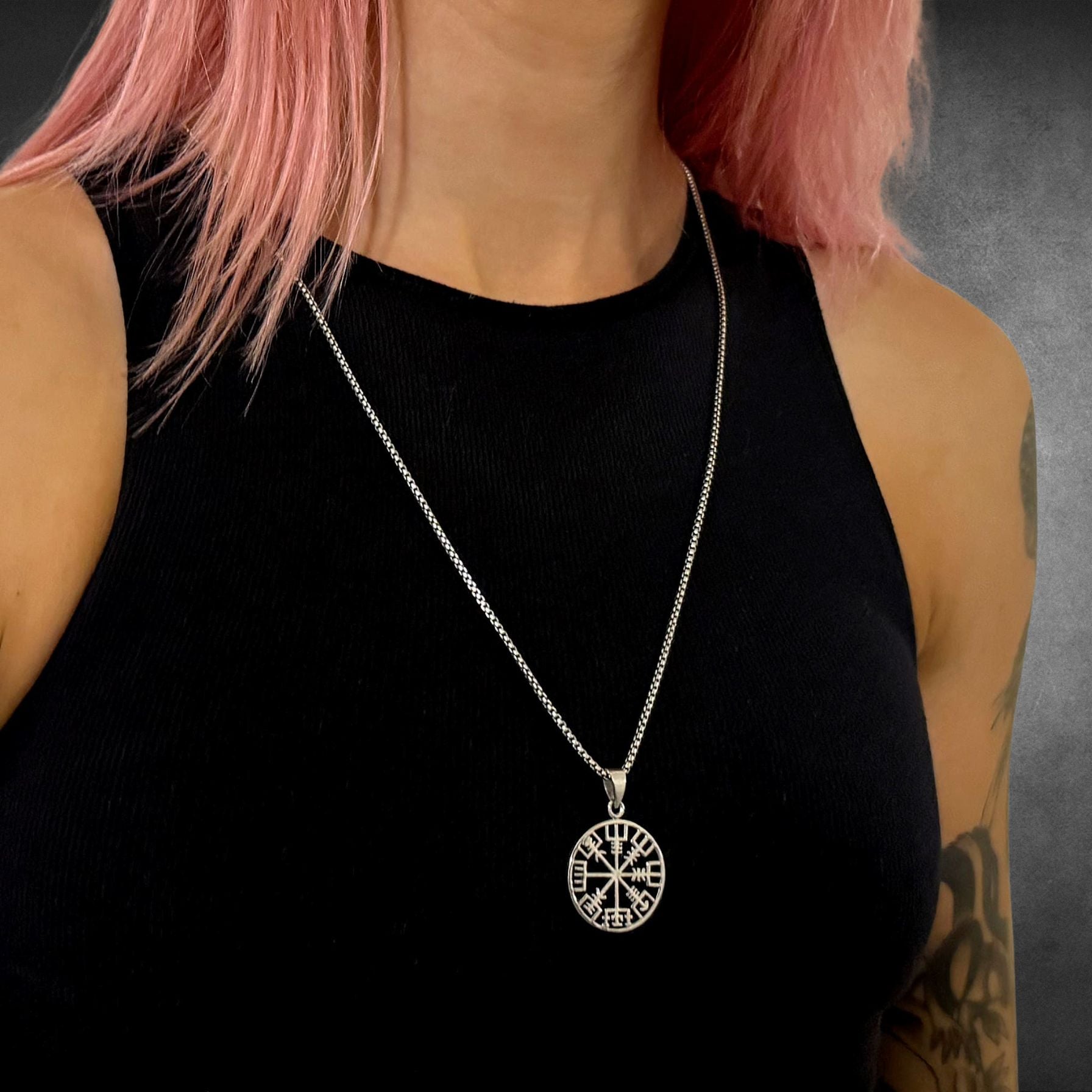 RECKLESS ROUTE compass on a 26-inch solid silver oxidised box chain,  modelled by a tattooed girl with pink hair 